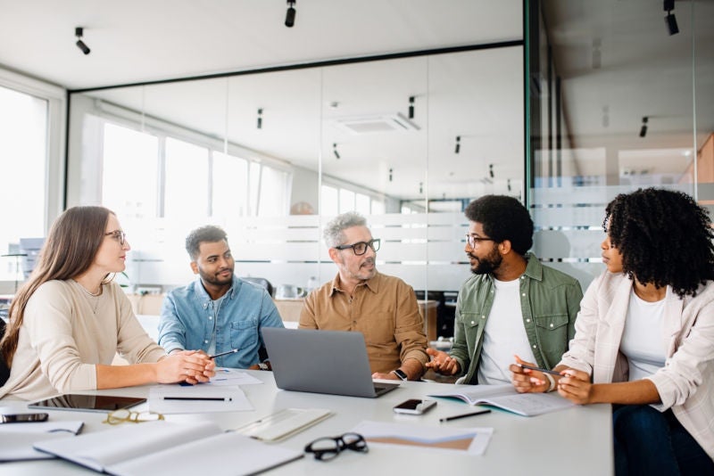 A business meeting in which different strategy perspectives are being batted around the table