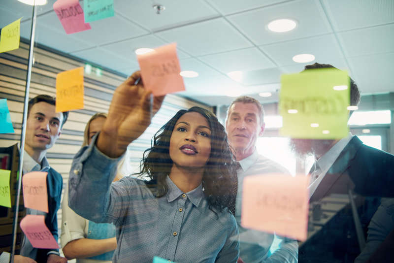 A business leader helping brainstorm new solutions with her team